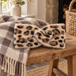 Tan cream and black leopard headband on a rustic bench