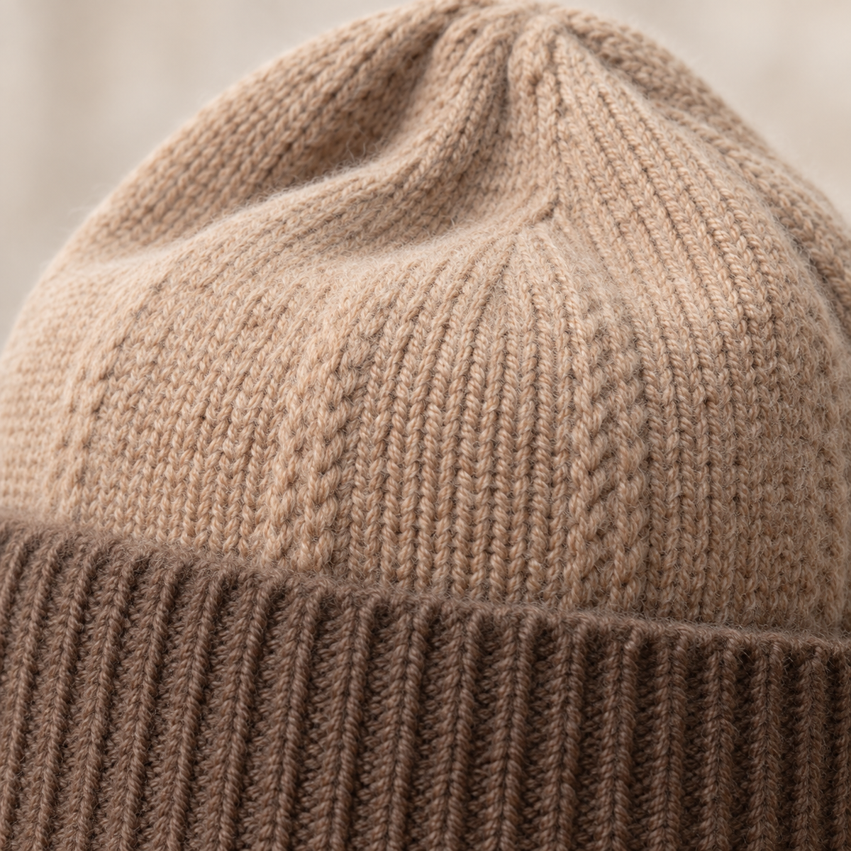Close-up of oatmeal crown and cappuccino rib cuff knit