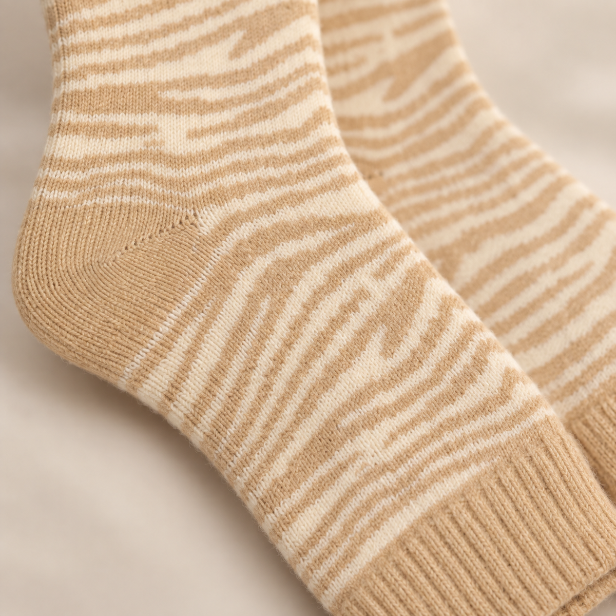 Close-up of the cream and oatmeal zebra knit pattern