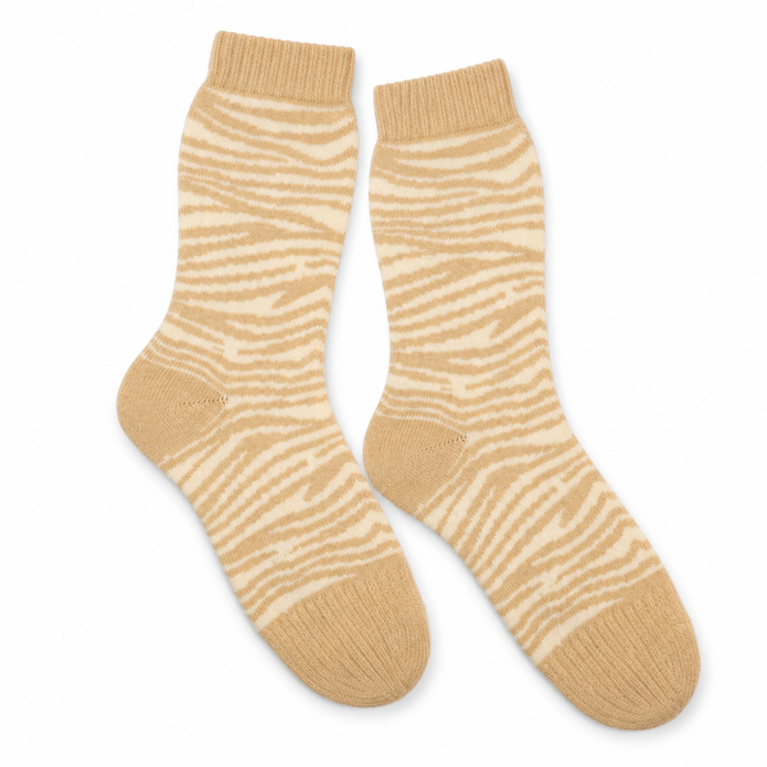 Pair of cream socks with oatmeal zebra stripes on white