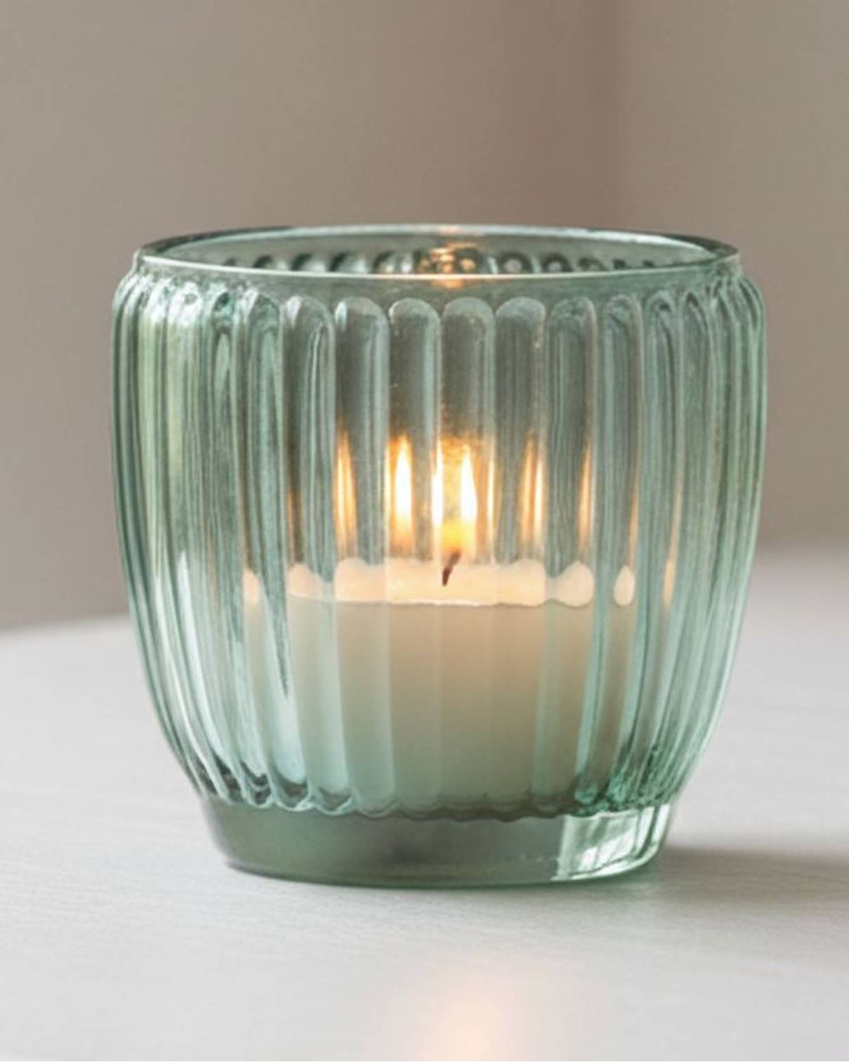 Blue glass tealight candle holders from Joe Davies, elegant home decor accents with a sleek, modern design.
