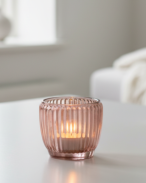 Pink glass tealight candle holders by Joe Davies, elegant home decor accents with a delicate, translucent design for warm ambient lighting.