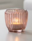 Pink glass tealight candle holders for home decor by Joe Davies, featuring elegant, transparent glass design.
