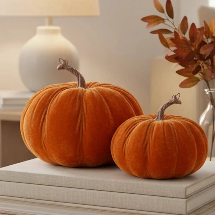 Close-up of orange velvet autumn pumpkins by Heaven Sends, showcasing textured fabric and detailed craftsmanship.
