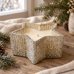 Silver glass star candle unlit on a winter oak table