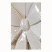 Close-up of the smooth glazed ceramic knot and folded loops of the white double bow