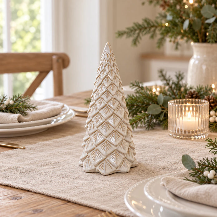 Ceramic pinecone Christmas tree on an oatmeal linen runner for a festive table setting