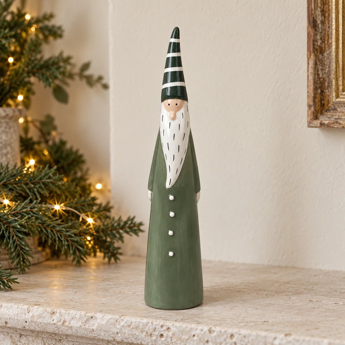 Large green Satchville ceramic Christmas gonk ornament displayed on a mantelpiece