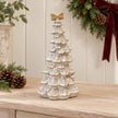 Large stone glazed ceramic bendy Christmas tree with cream bow styled in a christmas console scene