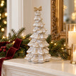 Large stone glazed ceramic bendy Christmas tree with cream bow styled in a christmas mantel scene