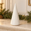 Large white ceramic Christmas tree by Satchville displayed on a mantel