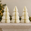 Three equal-sized winter white paper Christmas trees side by side on a stone mantel.