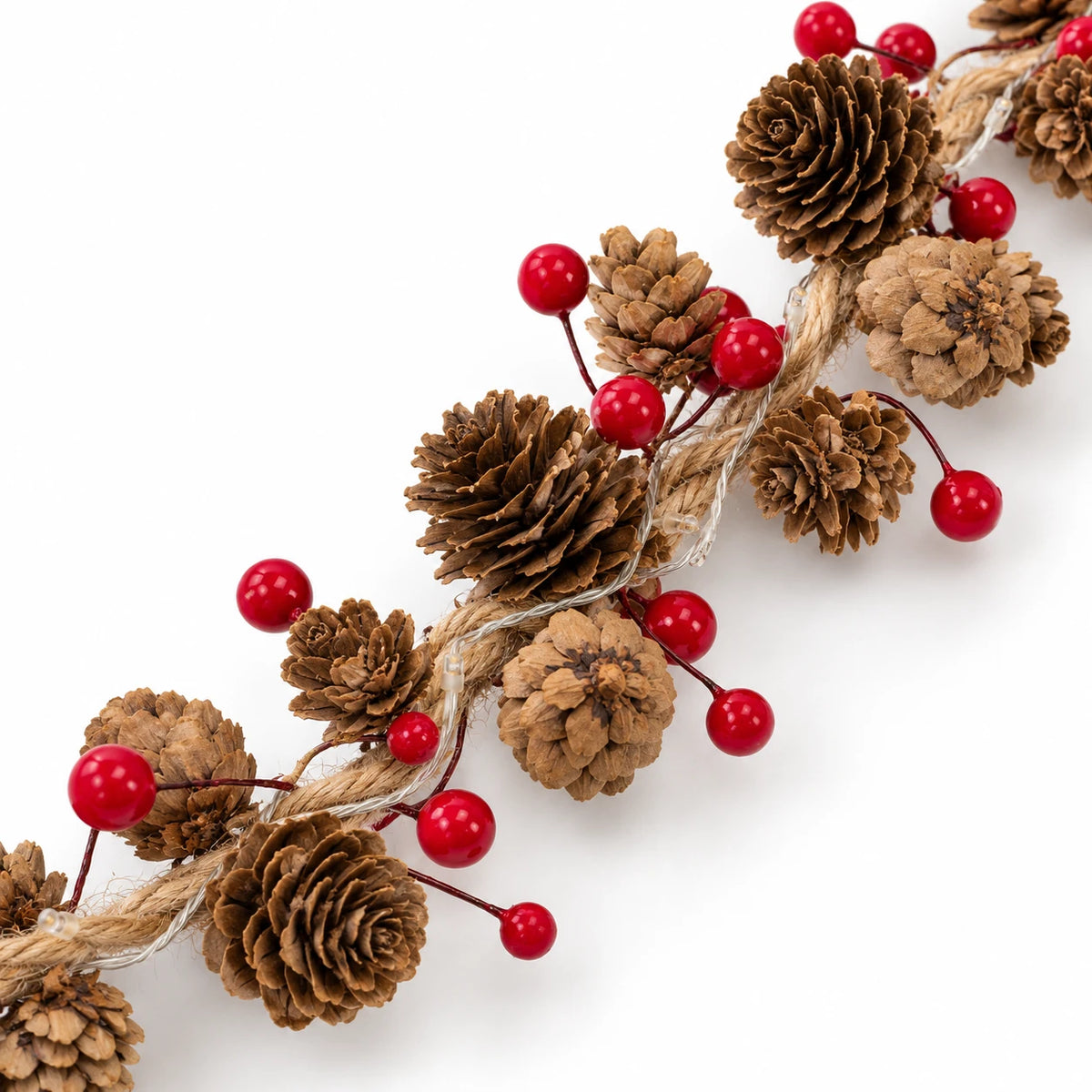 Close-up of natural pinecones, glossy red berries, jute cord and unlit LEDs on the garland.