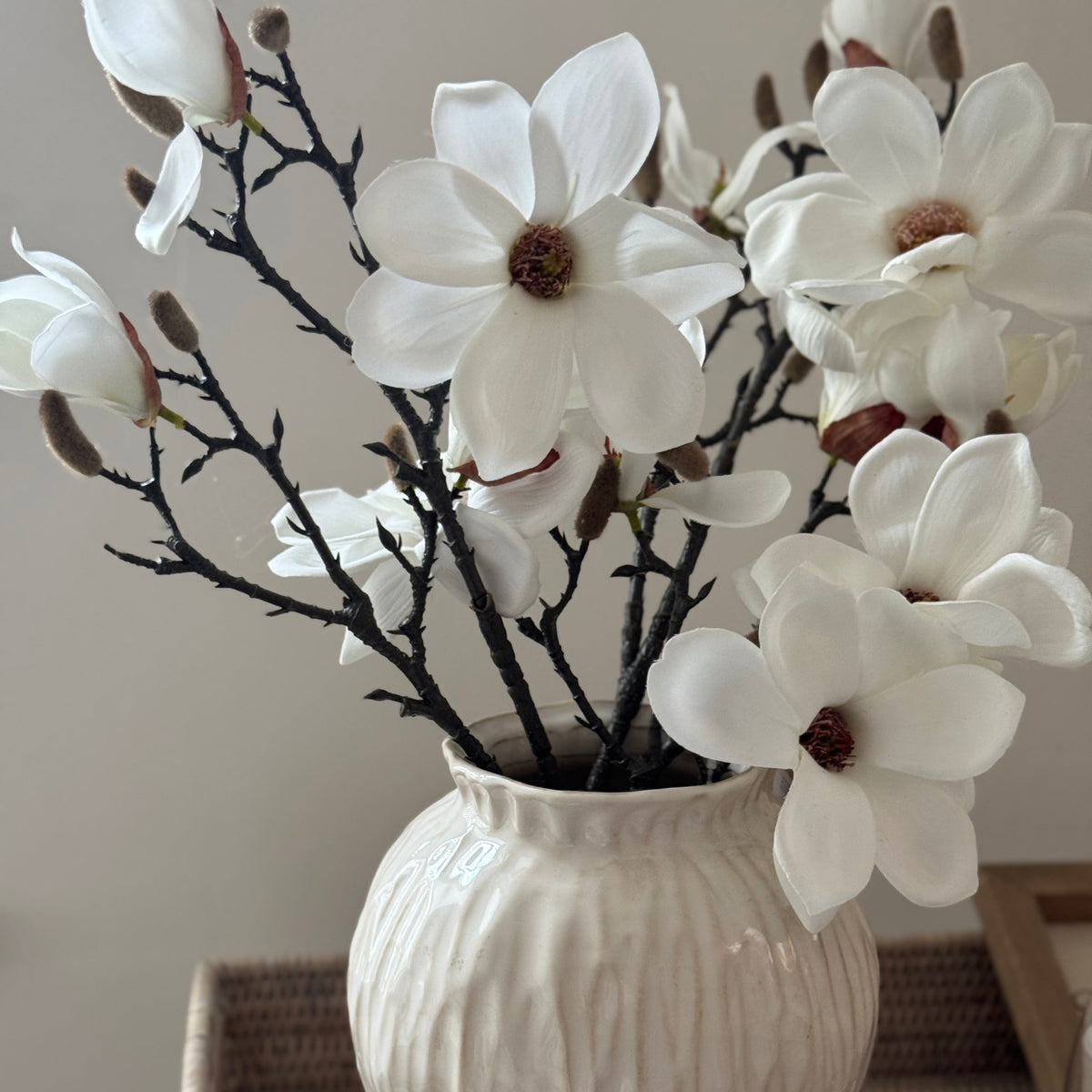 Artificial white magnolia branch stem by Hill Interiors with lifelike blossoms and green leaves