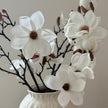 Artificial white magnolia branch stem by Hill Interiors in bloom, with realistic flowers and green leaves