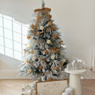 7ft pre-lit luxury snowy Lorax Christmas tree by Starlight Express, decorated with warm white lights