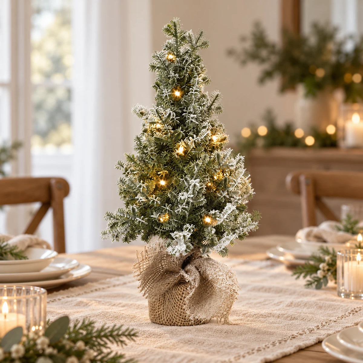 Frosted light-up Christmas tree with hessian base on a neutral Christmas dining table