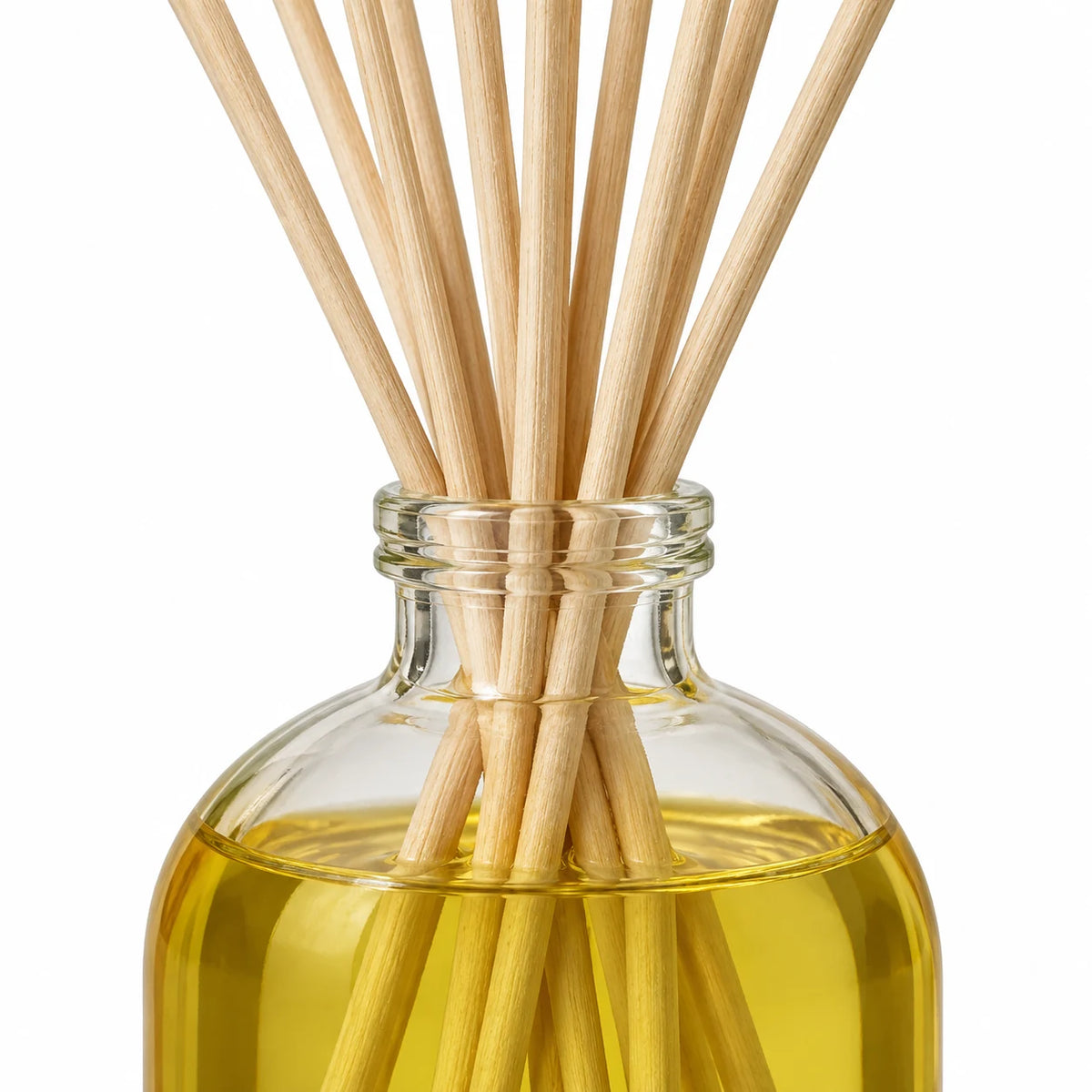 Heaven Scent LIME, BASIL & MANDARIN 100ml reed diffuser close-up of natural rattan reeds and the glass bottle neck.