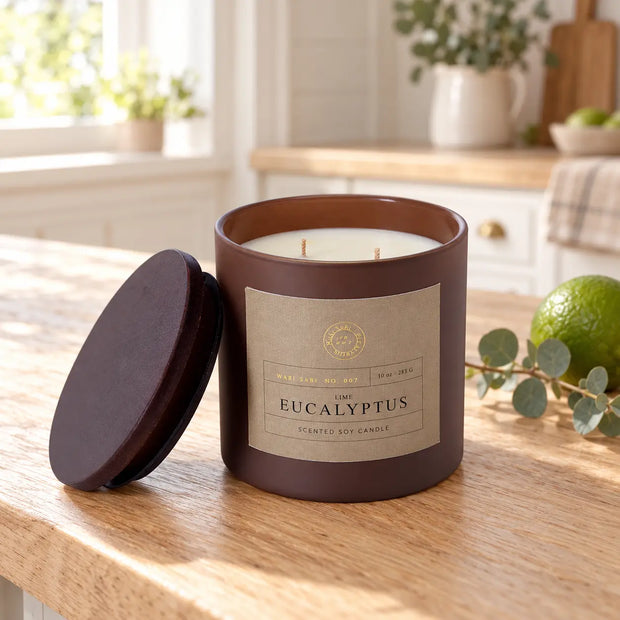 Lime and eucalyptus soy candle styled with a lime and eucalyptus sprig in a bright country kitchen
