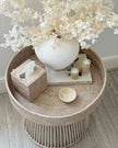 Lows rattan round side table with a natural woven design, perfect as a stylish accent piece in living spaces.