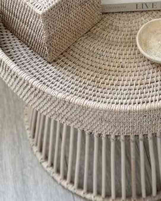 Lows rattan round side table with a natural woven surface and wooden legs, ideal for living room or patio decor.