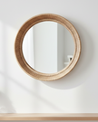 Natural rattan round mirror for home decor, featuring a woven rattan frame, ideal for adding a stylish touch to any room.
