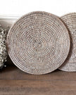 Set of two Lows rattan round placemats for home decor, showing woven natural rattan with a circular design.