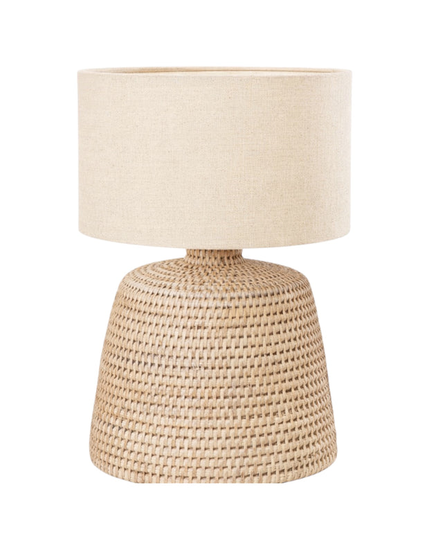 Lows rattan small table lamp with fabric shade for home decor, featuring a natural woven rattan base and soft lighting.
