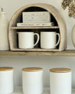Lows rattan arched-shaped shelving unit for kitchen and dining, featuring open storage and natural woven design.