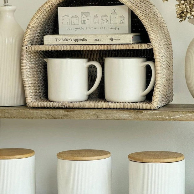 Lows rattan arched-shaped shelving unit for kitchen and dining, featuring open storage and natural woven design.