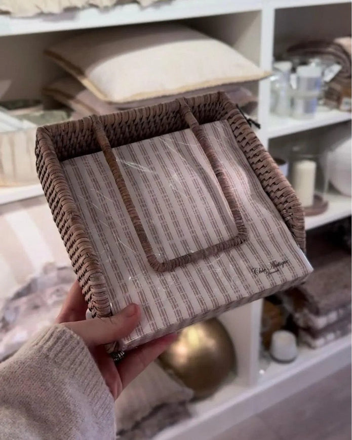 Lows rattan napkin holder with weight for kitchen and dining, featuring a natural woven design and sturdy base for holding napkins.