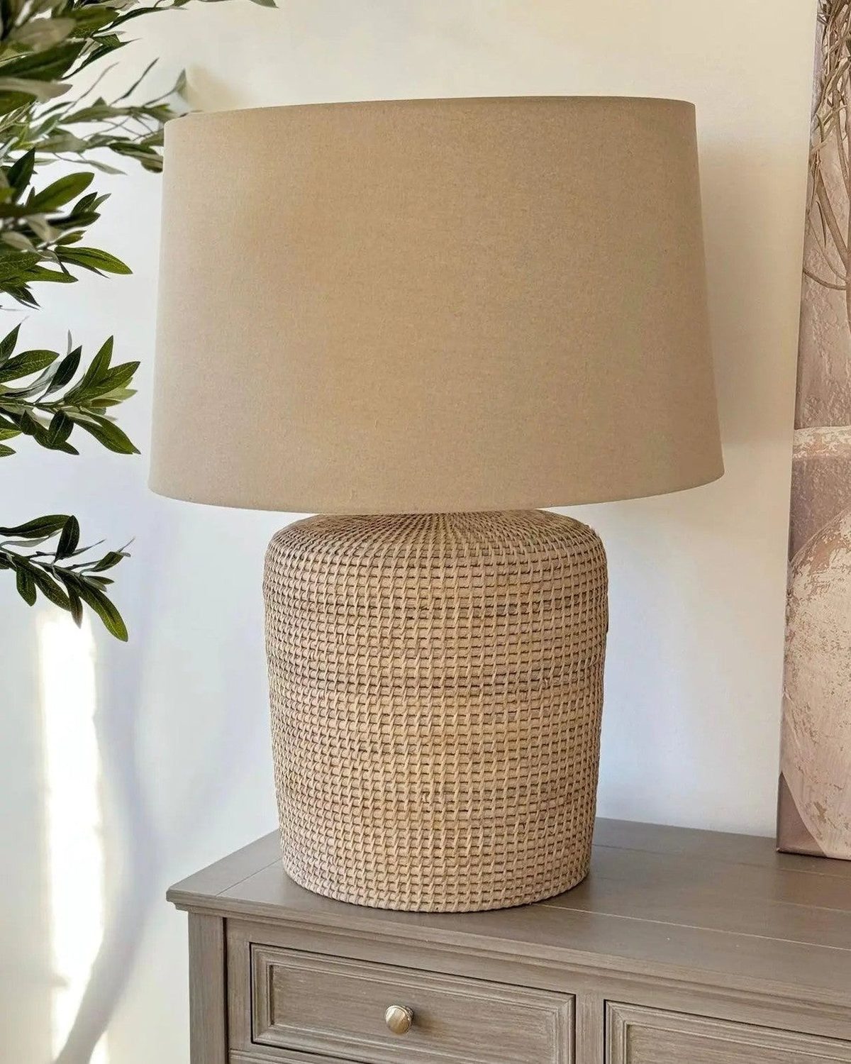 Large rattan table lamp by Lows, featuring a woven rattan shade and sturdy base, ideal for ambient lighting in living spaces.