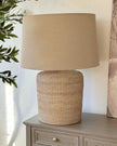 Large rattan table lamp by Lows, featuring a woven rattan shade and sturdy base, ideal for ambient lighting in living spaces.