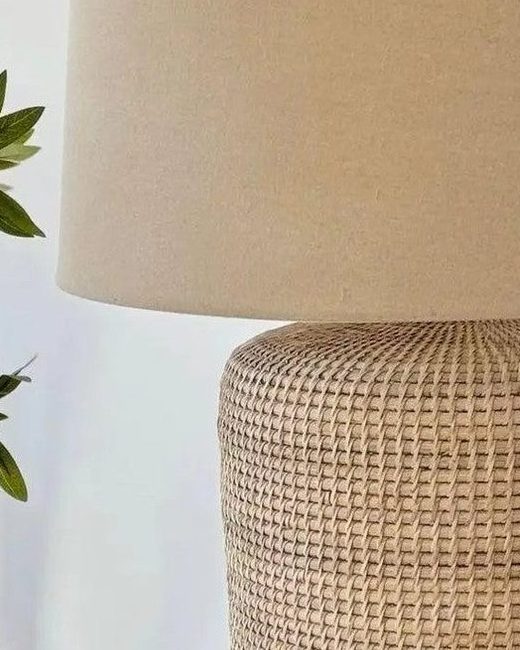 Large rattan table lamp by Lows, with woven rattan shade and wooden base, designed for stylish lighting in living spaces.