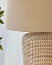 Large rattan table lamp by Lows, with woven rattan shade and wooden base, designed for stylish lighting in living spaces.
