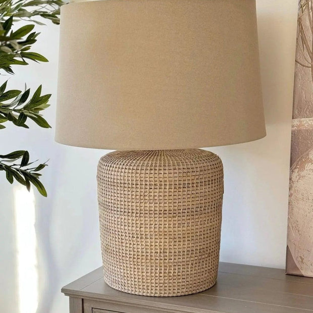 Large rattan table lamp by Lows, featuring a woven rattan base and a fabric lampshade for stylish lighting.