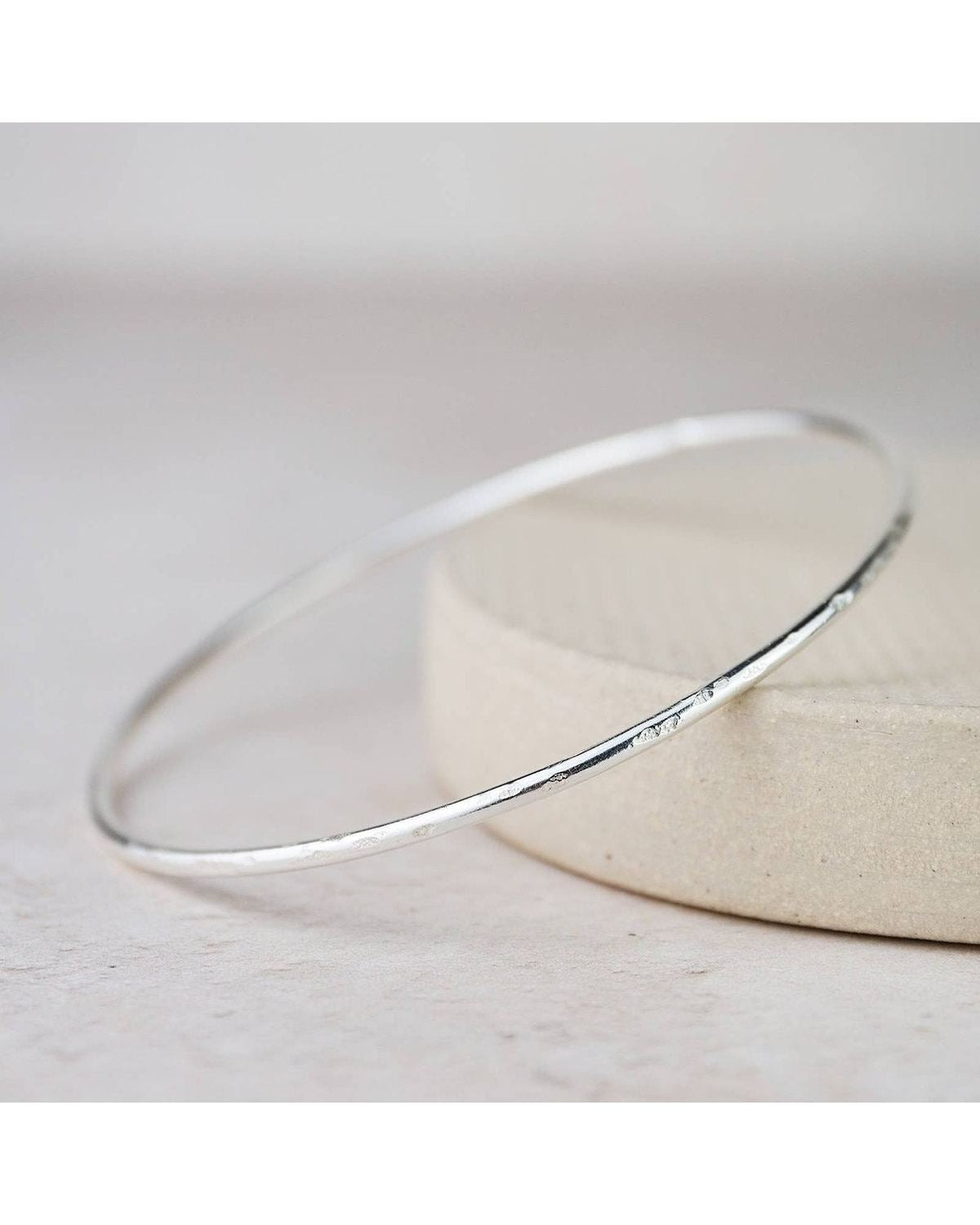 Sterling silver geo circle bangle bracelet from Lucy Kemp Jewellery, featuring a modern circular design for stylish wristwear.