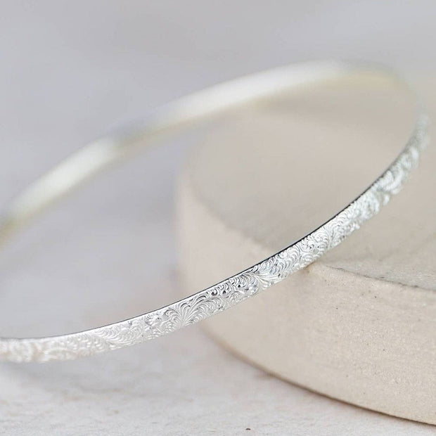 Sterling silver lace bangle bracelet by Lucy Kemp Jewellery, showcasing intricate lace design and polished silver finish.