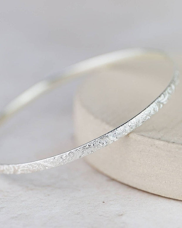 Sterling silver lace bangle bracelet by Lucy Kemp Jewellery, showcasing intricate lace design and polished silver finish.