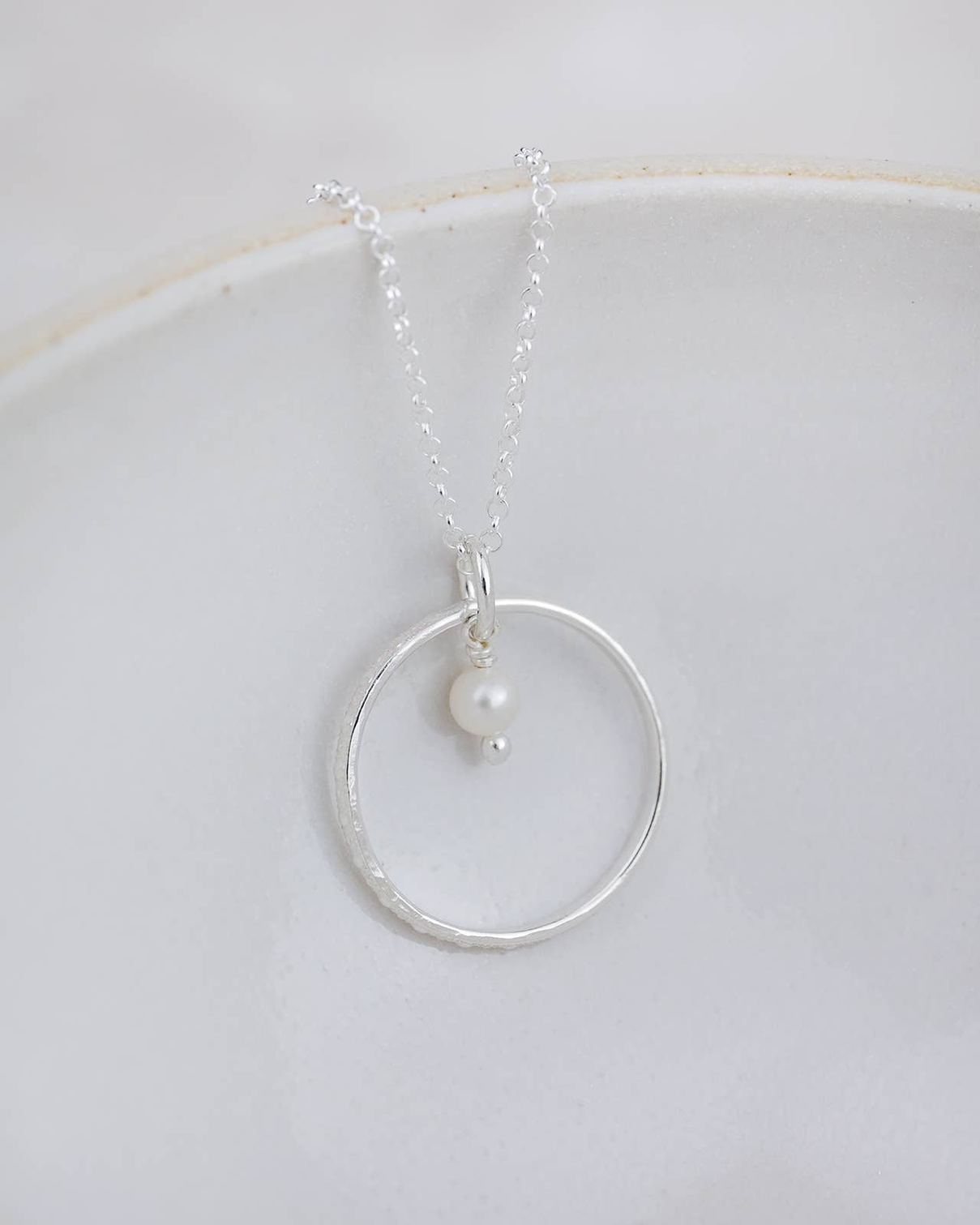 Sterling silver celestial hoop pendant necklace with a pearl, elegant jewelry piece by Lucy Kemp Jewellery.
