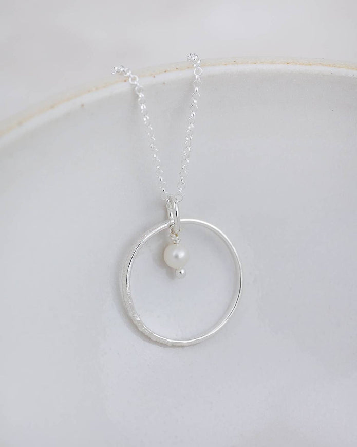 Sterling silver celestial hoop pendant necklace with a pearl, elegant jewelry piece by Lucy Kemp Jewellery.