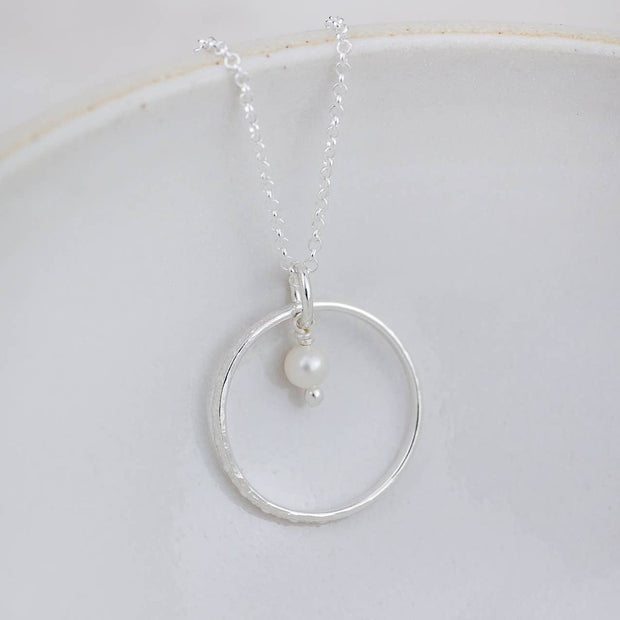 Sterling silver celestial hoop pendant necklace with a pearl, elegant jewelry piece by Lucy Kemp Jewellery.