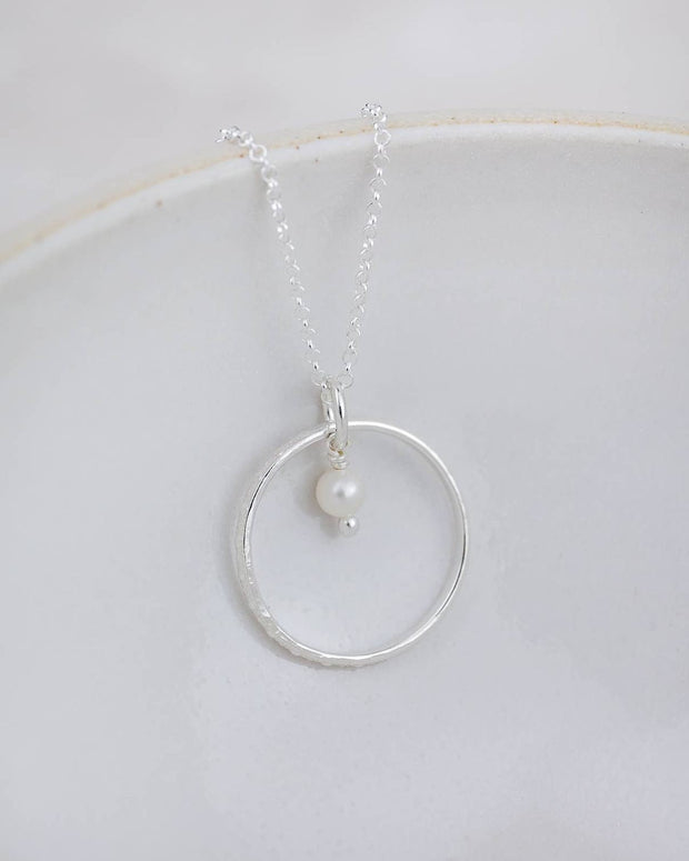 Sterling silver celestial hoop pendant necklace with a pearl, elegant jewelry piece by Lucy Kemp Jewellery.