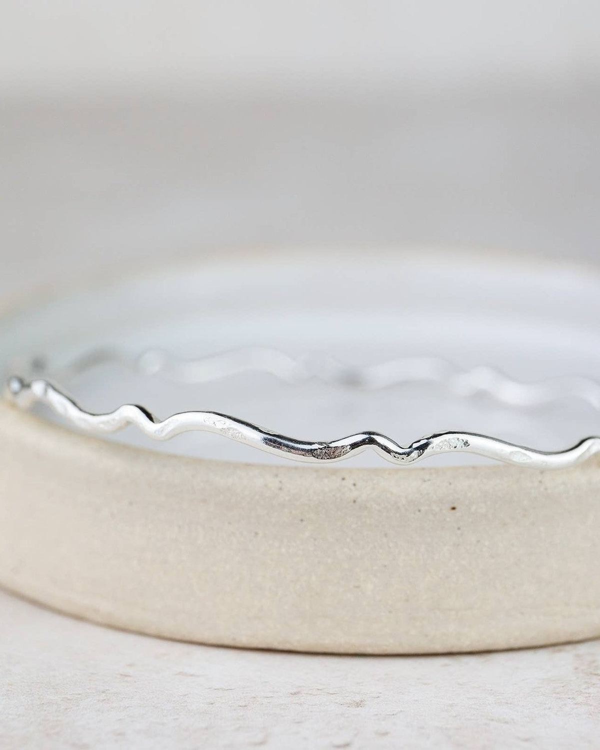 Sterling silver Geo Scroll bangle bracelet by Lucy Kemp Jewellery featuring intricate scroll patterns and sleek design.