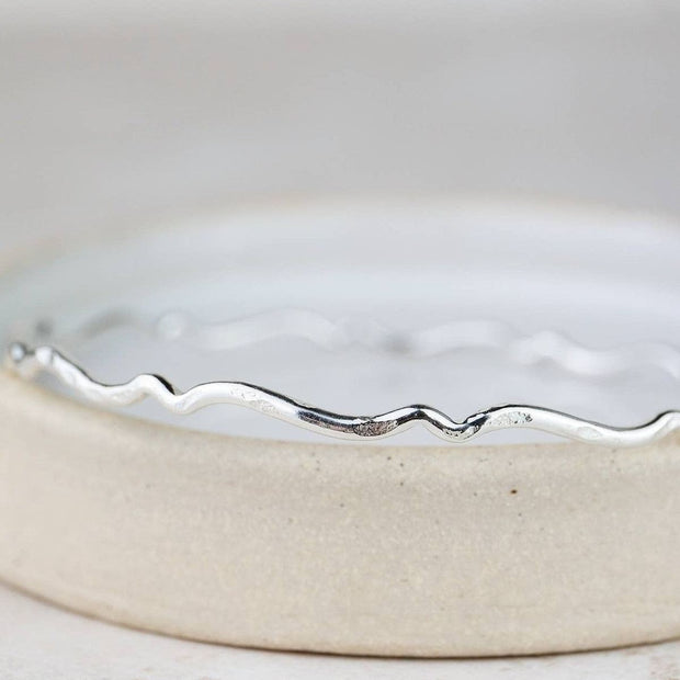 Sterling silver Geo Scroll bangle bracelet by Lucy Kemp Jewellery featuring intricate scroll patterns and sleek design.