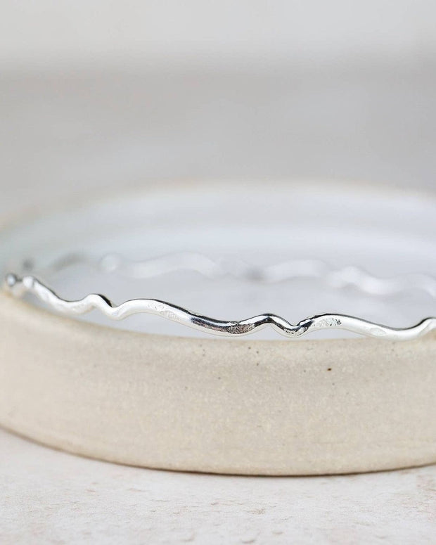 Sterling silver Geo Scroll bangle bracelet by Lucy Kemp Jewellery featuring intricate scroll patterns and sleek design.