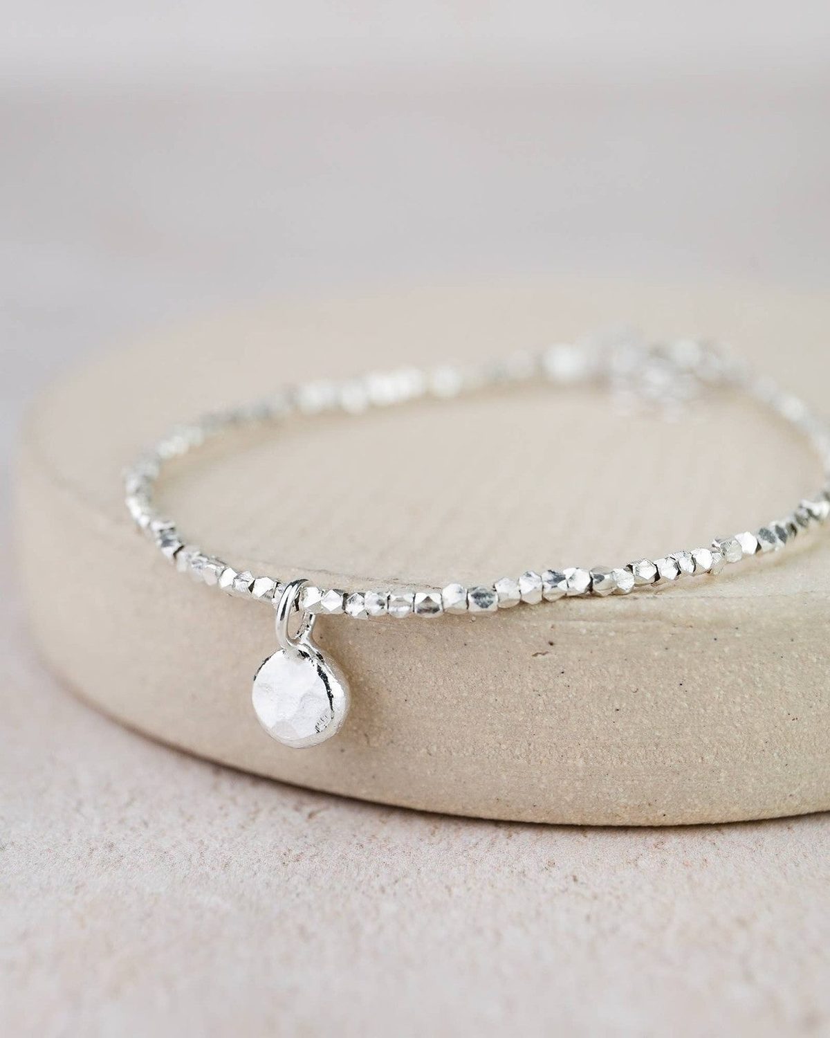 Sterling silver nugget charm bracelet by Lucy Kemp Jewellery featuring textured silver nuggets on a delicate chain.