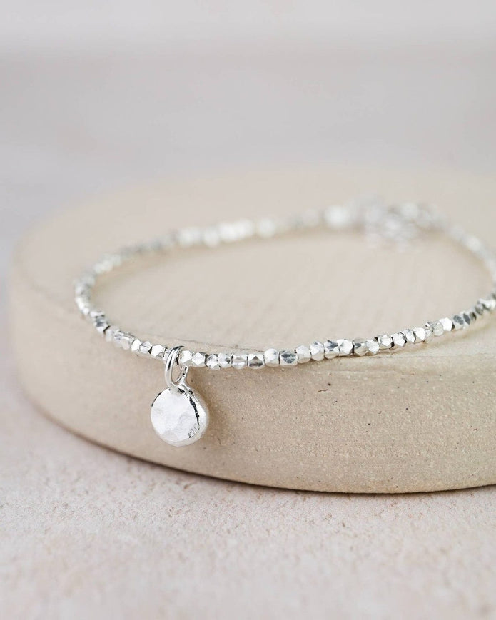 Sterling silver nugget charm bracelet by Lucy Kemp Jewellery featuring textured silver nuggets on a delicate chain.