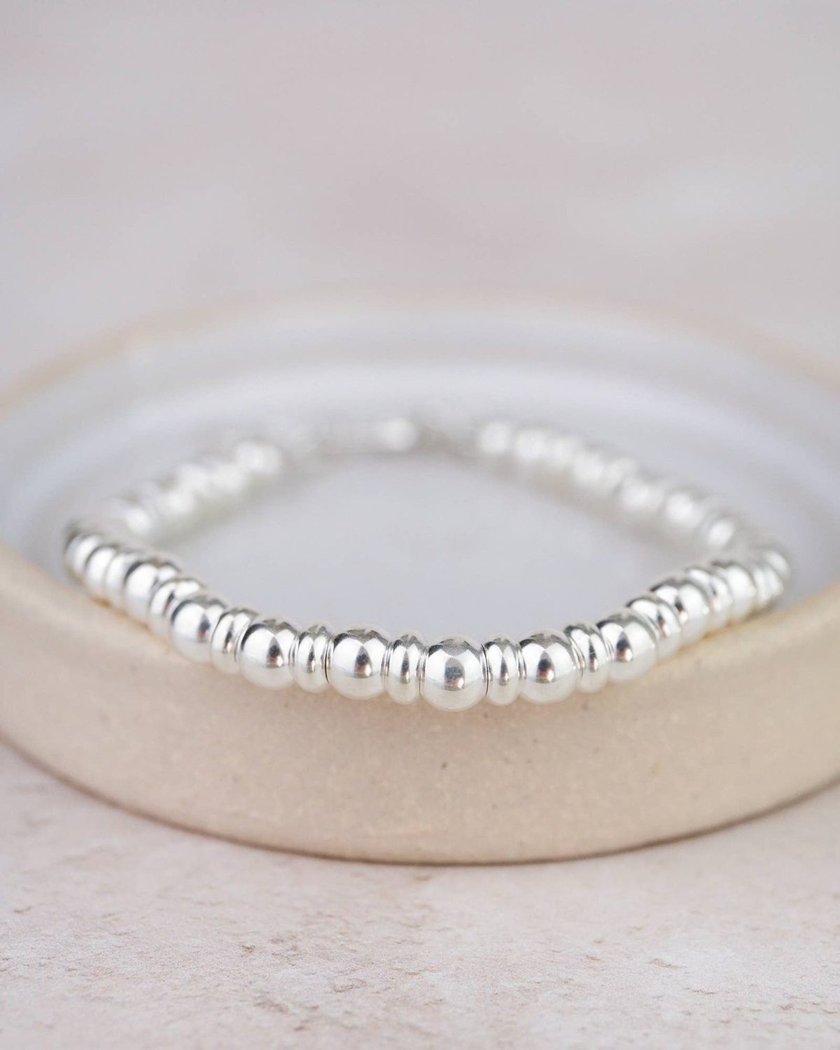 Sterling silver two-bead bracelet by Lucy Kemp Jewellery featuring minimalist jewelry design and smooth bead accents.