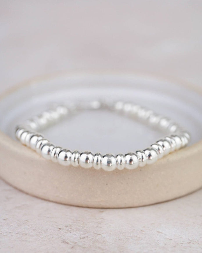 Sterling silver two-bead bracelet by Lucy Kemp Jewellery featuring minimalist jewelry design and smooth bead accents.